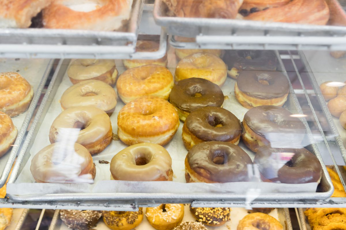 A glass case of doughnuts.