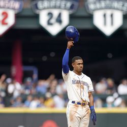 SEATTLE, WASHINGTON - SEPTEMBER 14: Julio Rodriguez #44 of the Seattle Mariners is acknowledged after stealing his 25th base and recording his 25th home run in a single rookie season during the fifth inning against the San Diego Padres at T-Mobile Park on September 14, 2022 in Seattle, Washington.