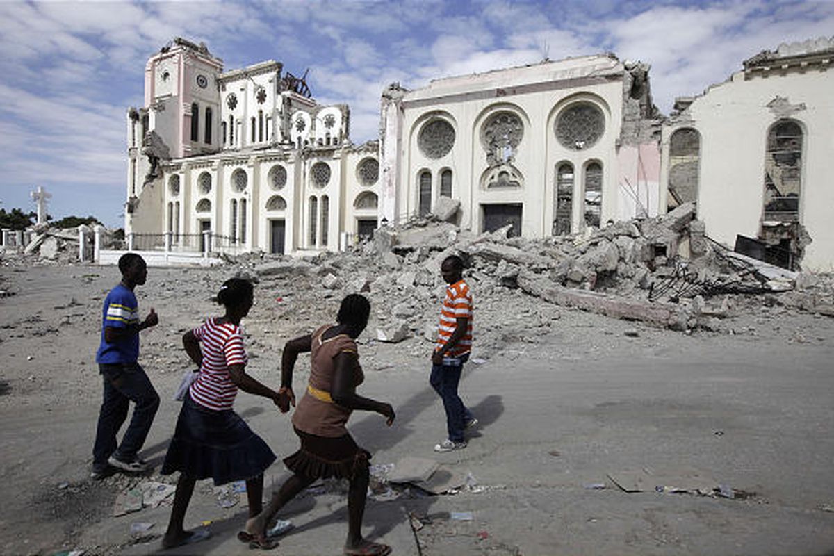 People walk by a cathedral that collapsed during an earthquake in Port-au-Prince, Haiti, in January.   