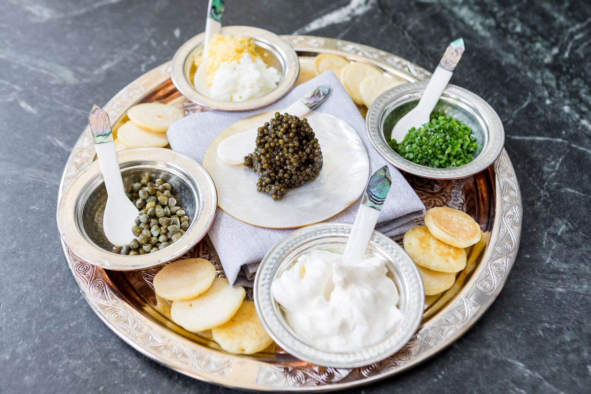 A tray with caviar and accoutrements.