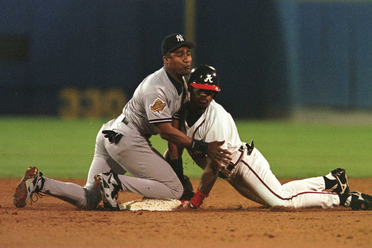 Former Yankee Mariano Duncan gets up close and personal with Braves outfielder Marquis Grissom during the 1996 World Series.