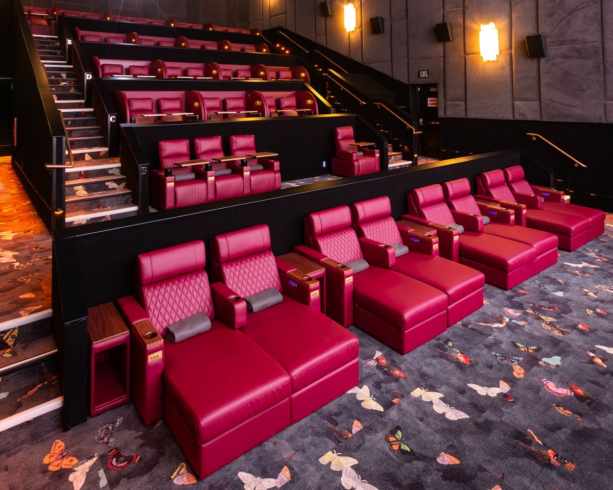 Reel Luxury Cinema’s movie theater with leather chaise lounge chairs and private viewing pods.