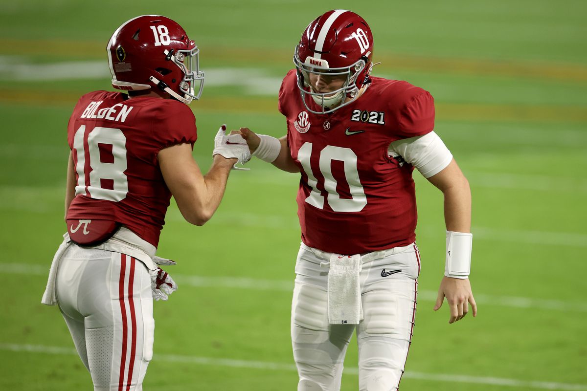 Mac Jones #10 and Slade Bolden #18 of the Alabama Crimson Tide get pumped up before the College Football Playoff National Championship held at Hard Rock Stadium on January 11, 2021 in Miami Gardens, Florida.