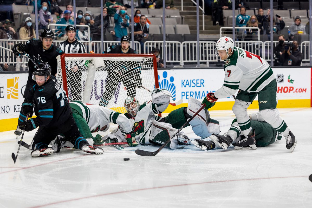 Minnesota Wild Center Nico Sturm (7) keeps the puck out of danger during the NHL pro hockey game between the Minnesota Wild and San Jose Sharks on December 9, 2021 at the SAP center in San Jose, CA.