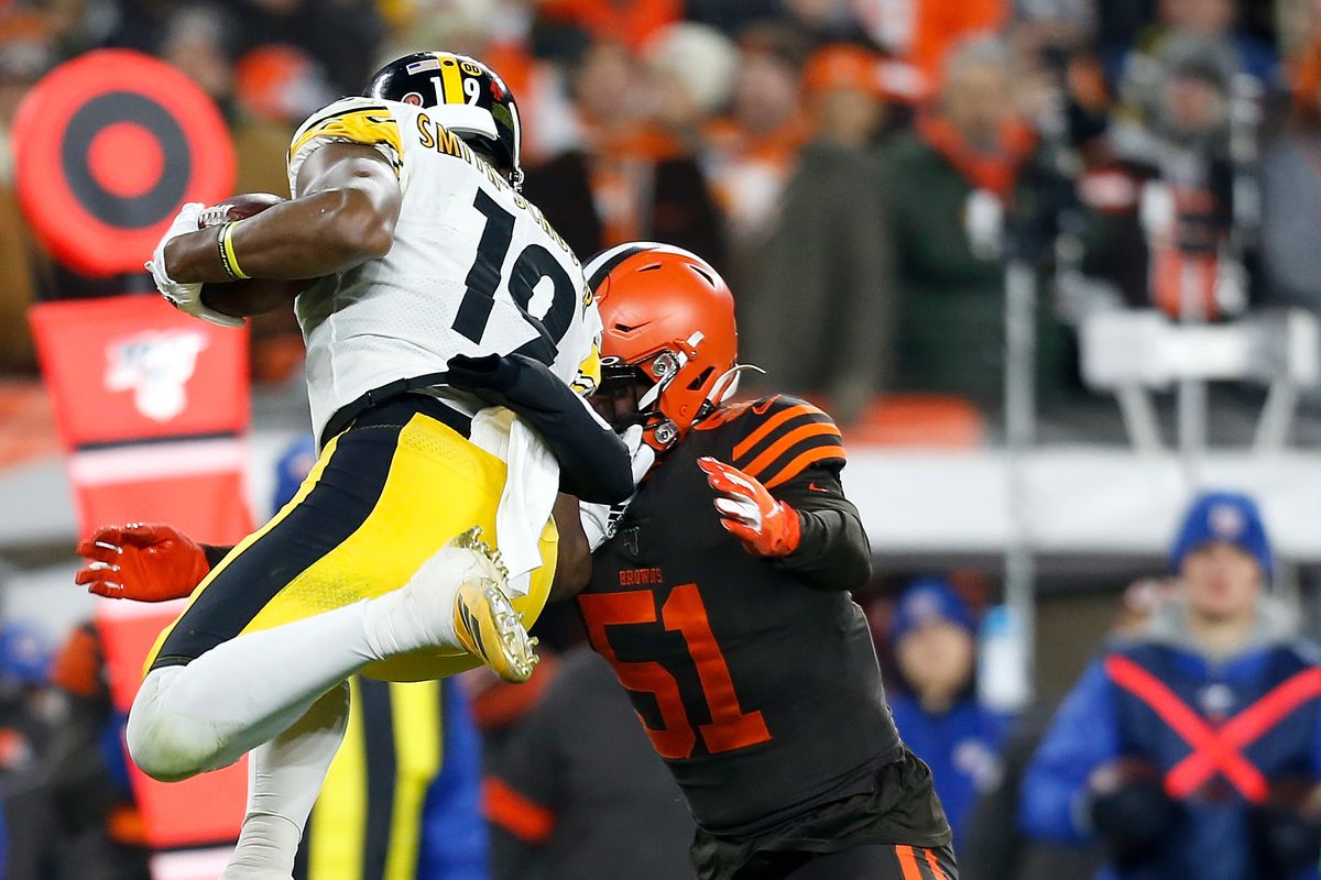 JuJu Smith-Schuster of the Pittsburgh Steelers is tackled by Mack Wilson of the Cleveland Browns during the first quarter at FirstEnergy Stadium on November 14, 2019 in Cleveland, Ohio.