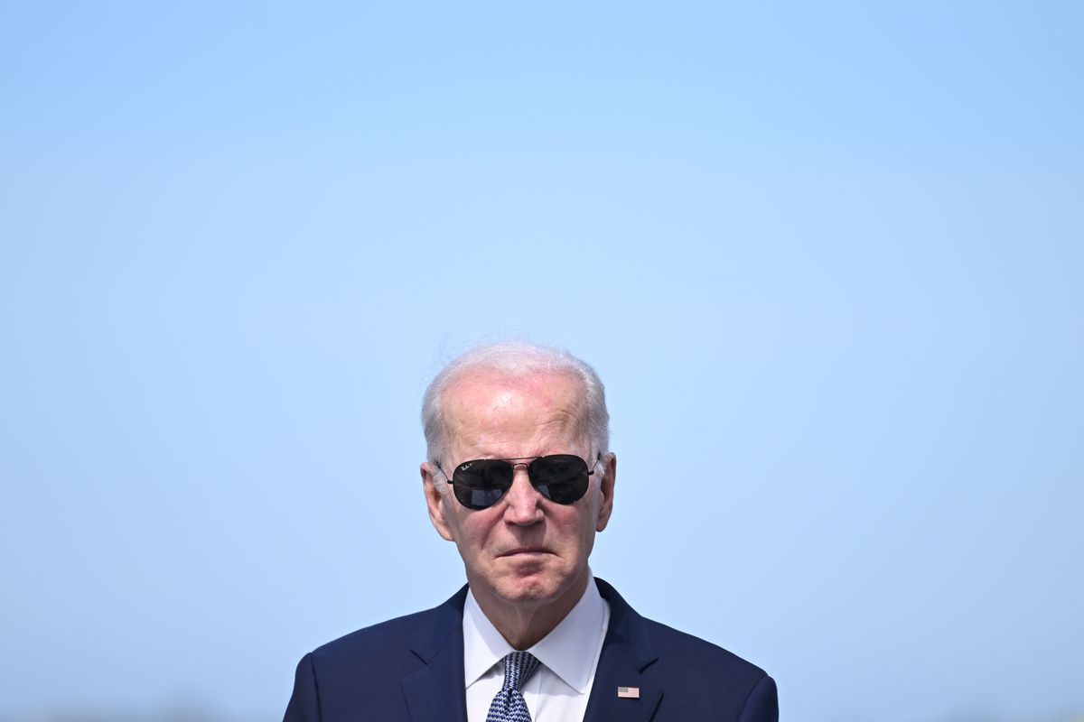 Joe Biden wearing sunglasses with a blue sky backdrop
