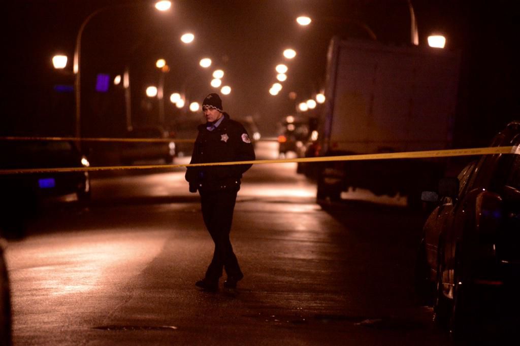 A Chicago Police officer at the scene where five people were shot on Monday night in Englewood. | Brian Jackson / Sun-Times