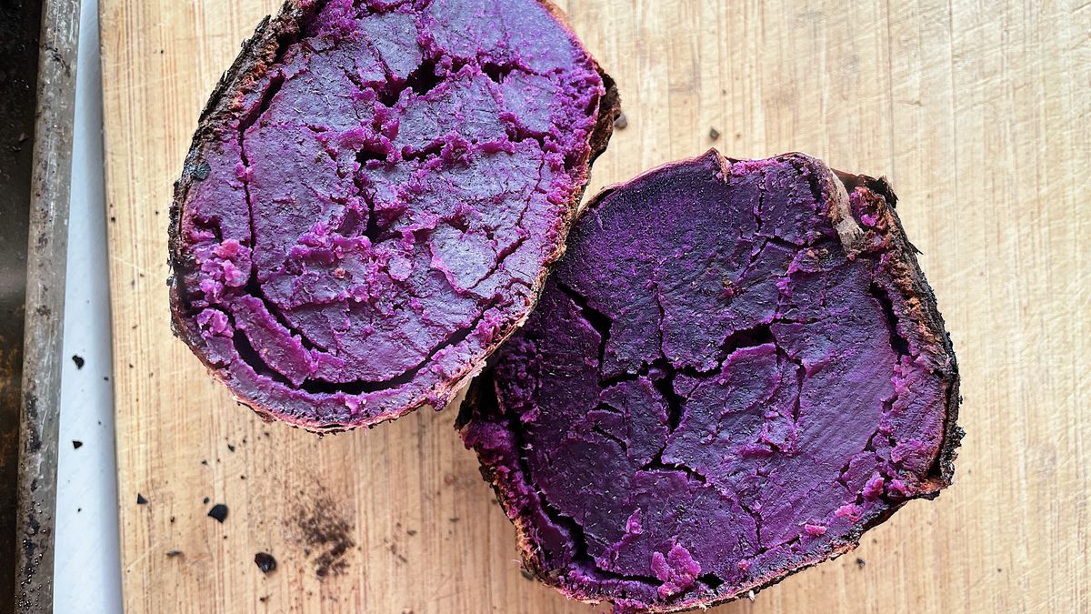 A purple frozen baked sweet potato, split in half