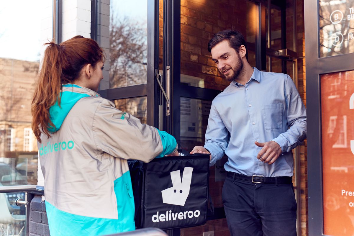 A Deliveroo driver delivers food to a customer, as the restaurant delivery company struggles with hacking