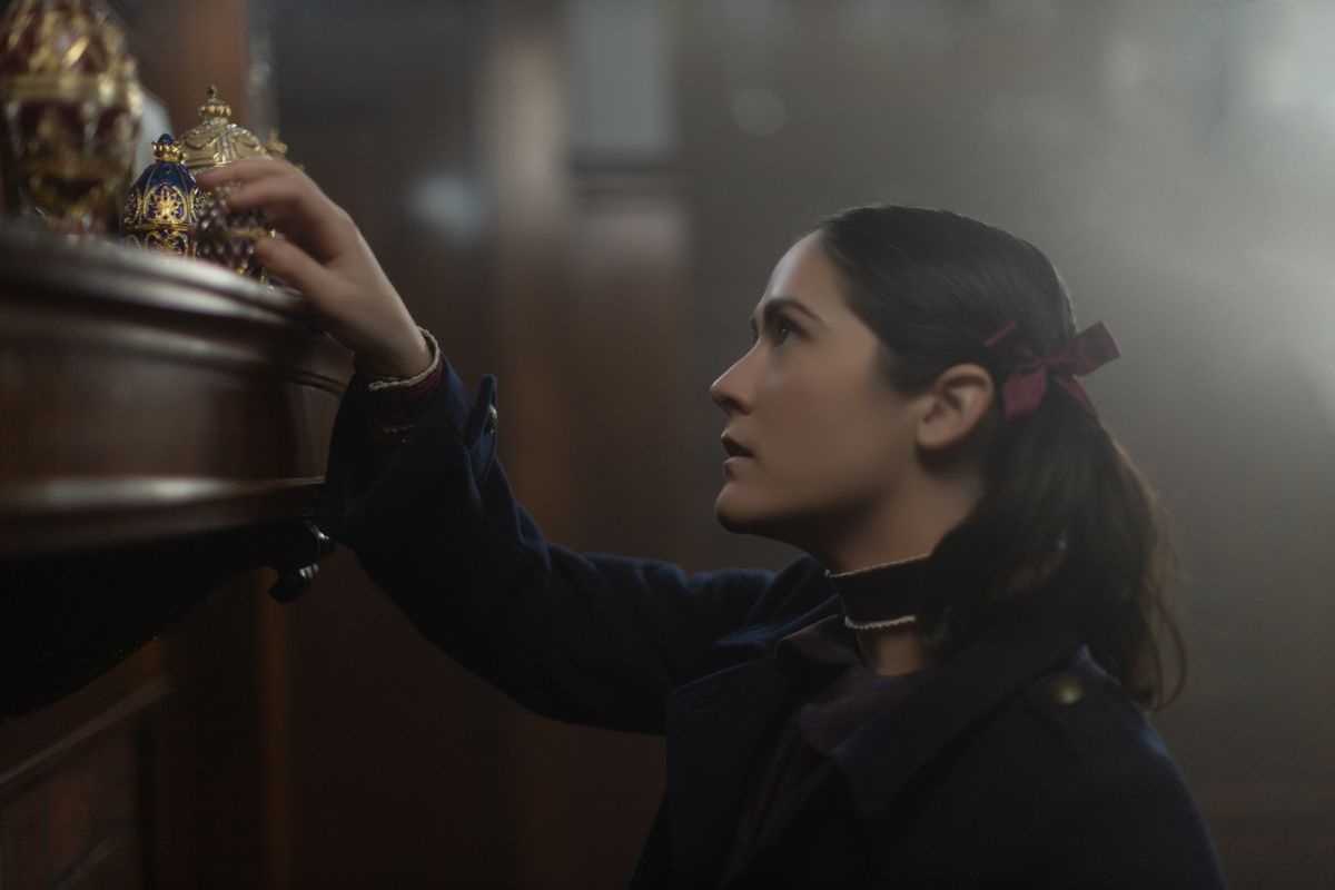 Isabelle Fuhrman investigates some jeweled items on a countertop as “Esther” in Orphan: First Kill