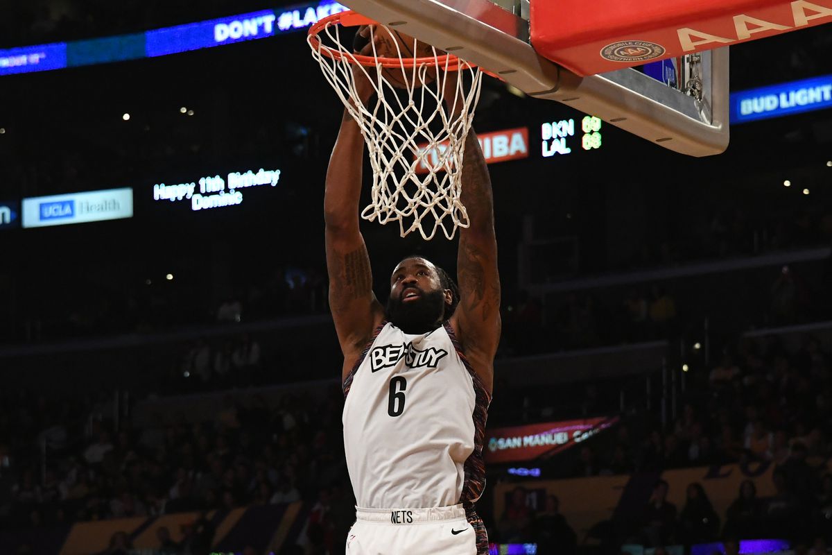 Brooklyn Nets center DeAndre Jordan hangs from the basket in the second half against the Los Angeles Lakers at Staples Center.
