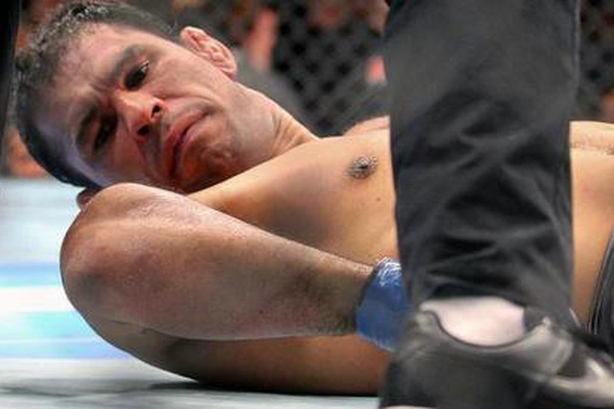 Antonio Rodrigo Nogueira stares at his broken arm following Frank Mir's bone crunching submission at UFC 140 on Dec. 10, 2011, in Toronto, Ontario, Canada. 
