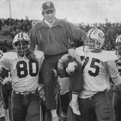 BYU head football coach LaVell Edwards is carried by Mekeli Leremia and Steve Dewey after beating Utah 34-12 Nov. 11, 1976.