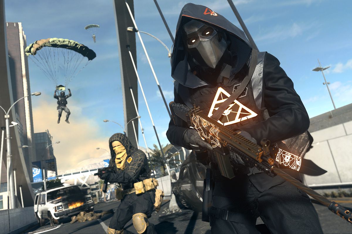 Hooded mercenary in glowing techwear and a mask holding guns on a bridge in Call of Duty Modern Warfare 2 and Warzone 2.0