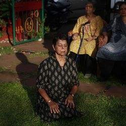 In this Tuesday June 9, 2015, photo, an Indian woman meditates with others after yoga practice early morning in a park in Mumbai, India. Yoga has a long history India, reaching back for thousands of years. Ancient temples show long-dead royalty in yoga poses. Tales of yogis who can rise into the air, or go long stretches without breathing, or cure terminal illnesses, are still told here. Sunday, June 21, 2015, marks the first International Yoga Day, which the government of Prime Minister Narendra Modi is marking with a massive outdoor New Delhi gathering.  