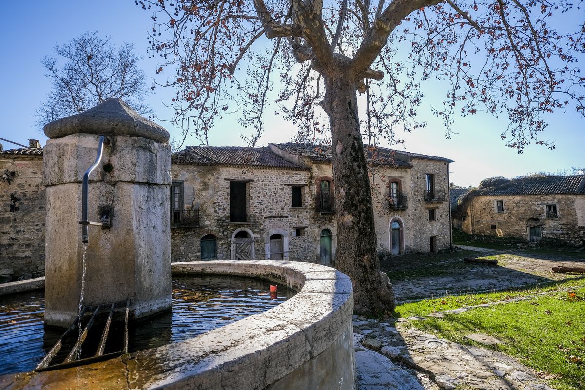 The central square with a fountain in the village located in...