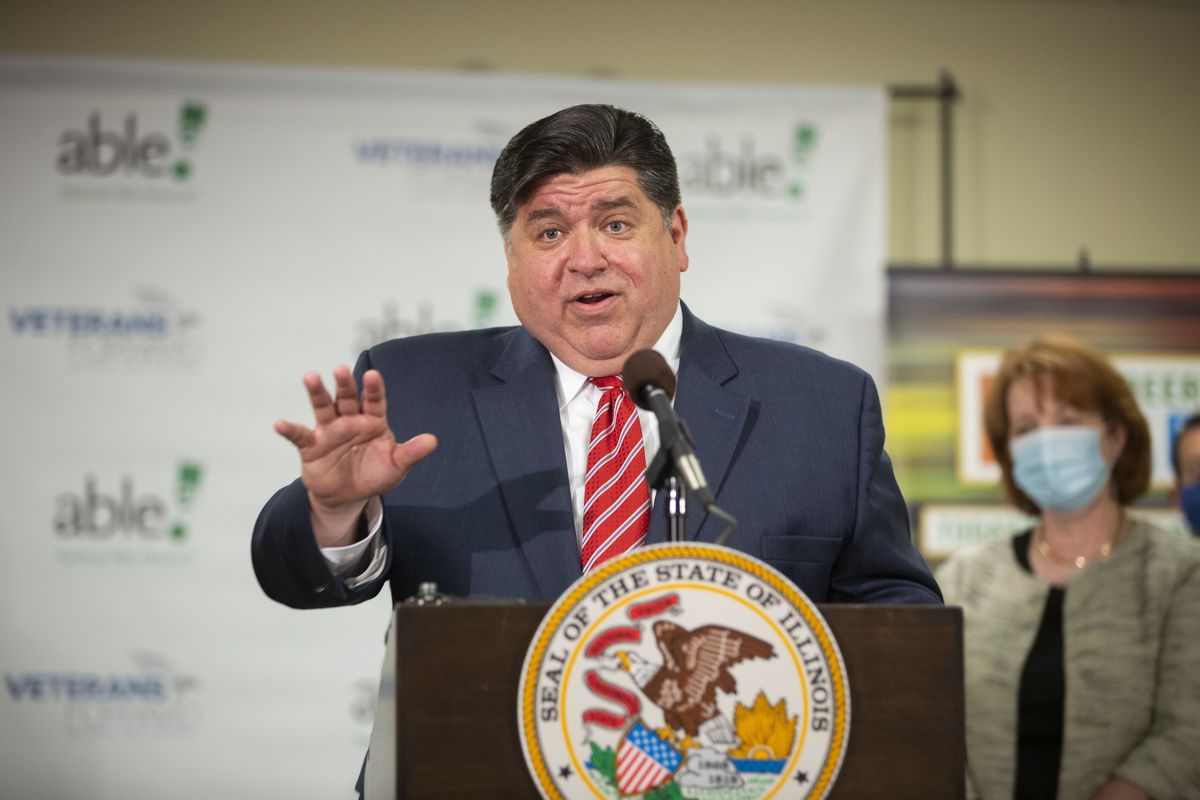 Gov. J.B. Pritzker answers questions during a news conference in the Heart of Chicago neighborhood in July.