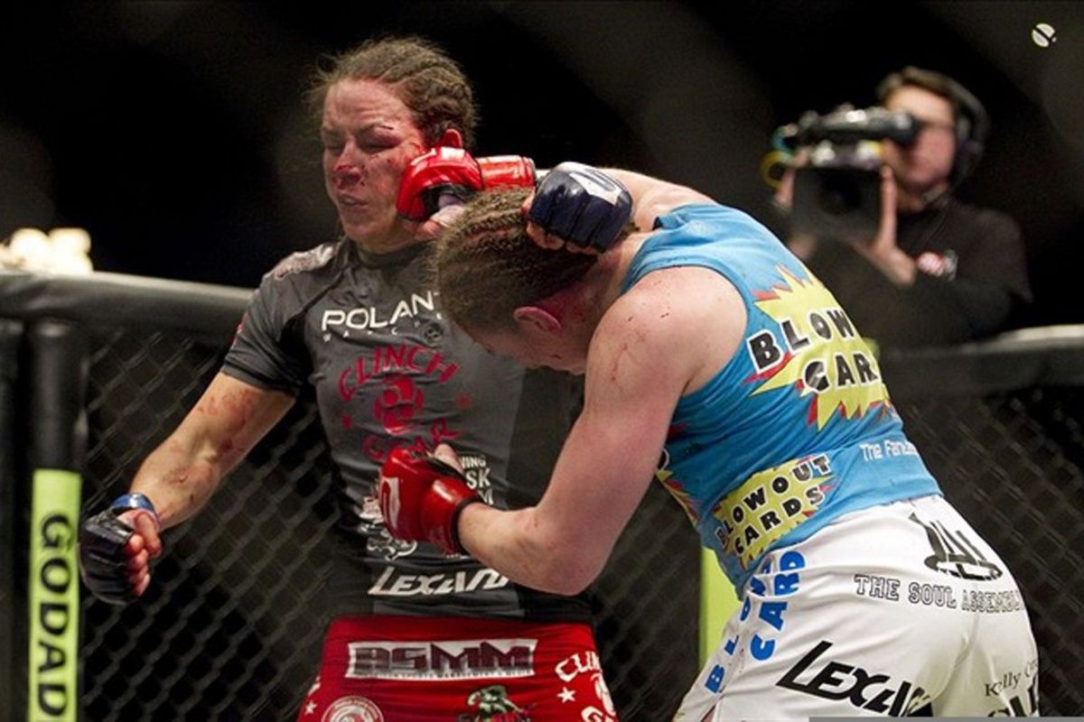 March 3, 2012; Columbus, OH, USA; Sarah Kaufman lands a right on a bloodied Alexis Davis  during the Strikeforce Grand Prix final at Nationwide Arena. Mandatory Credit: Greg Bartram-US PRESSWIRE