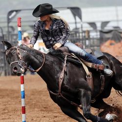 Maria Shiner spins her horse around a pole as they compete in the pole bending portion of the High School rodeo finals Wednesday, June 12, 2013 in Heber City.