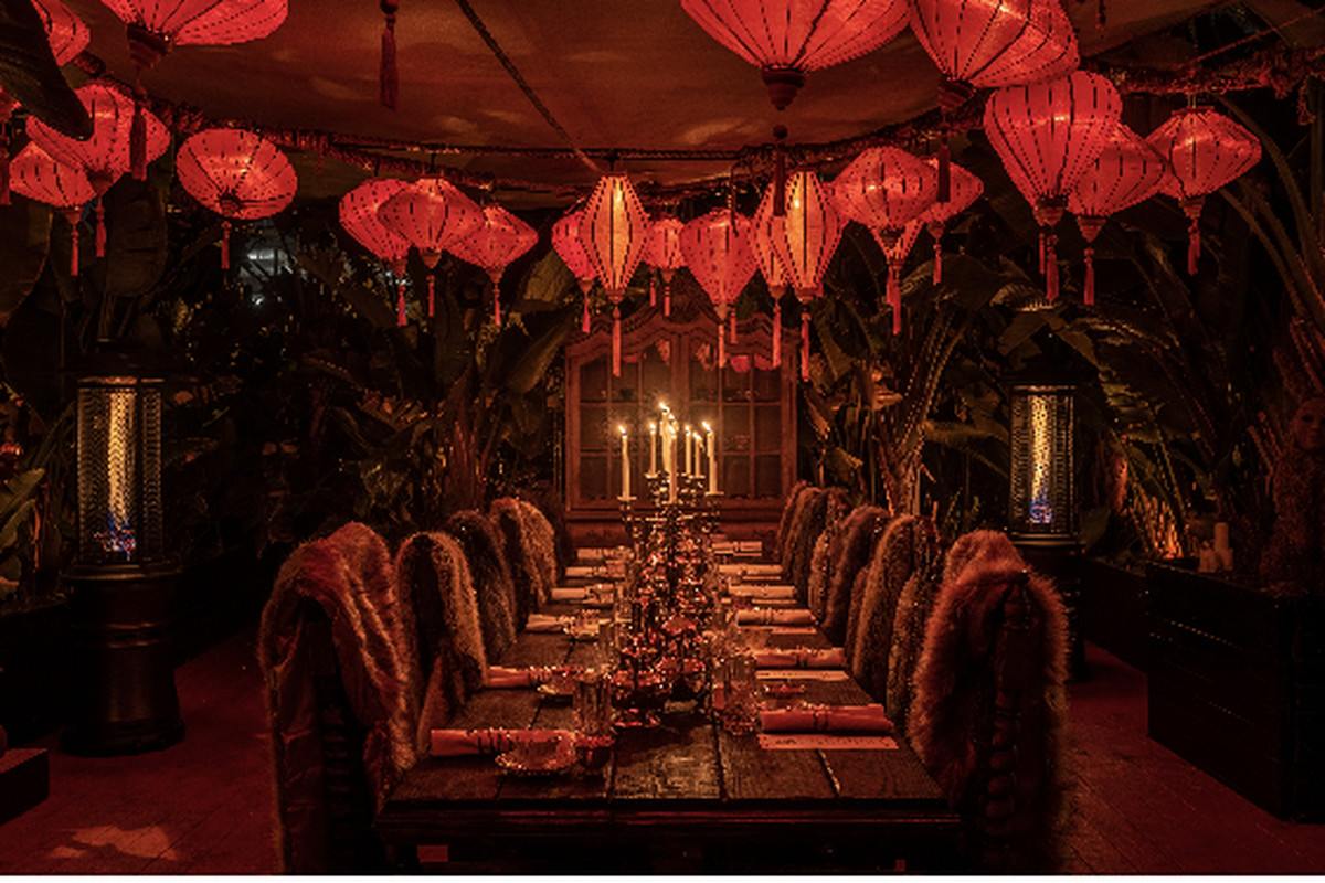The ornate, plush red interior of the private dining room at Lost Spirits Distillery in Los Angeles.