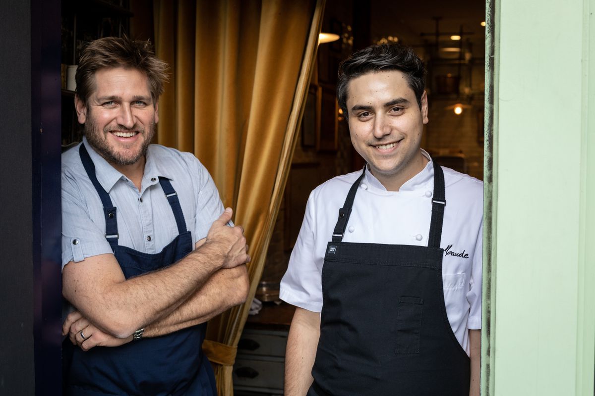 Curtis Stone and Osiel Gastelum of Maude restaurant in Beverly Hills wearing white coast and black aprons.