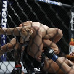 Luis Pena tries for the submission.