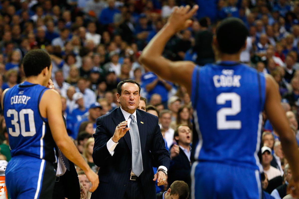 Head coach Mike Krzyzewski of the Duke Blue Devils and Seth Curry, left, and Quinn Cook, right, played on Super Bowl Sunday in 2012