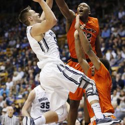 Brigham Young Cougars guard Kyle Collinsworth (5) shoots over Pacific Tigers forward Eric Thompson (12) at the Marriott Center Saturday, Feb. 14, 2015. BYU beat the Tigers, 84-59.