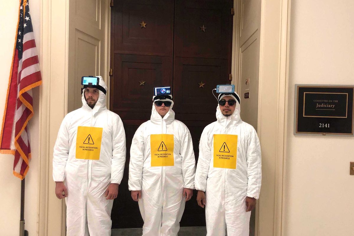 Dressed in hazmat-like jumpsuits, wearing smartphones strapped to their heads, activists descend upon Congress to protest facial recognition.