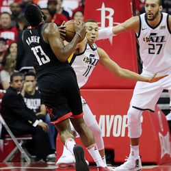 Utah Jazz guard Dante Exum (11) takes the ball away from Houston Rockets guard James Harden (13) as the Utah Jazz and the Houston Rockets play game two of the NBA playoffs at the Toyota Center in Houston on Wednesday, May 2, 2018.