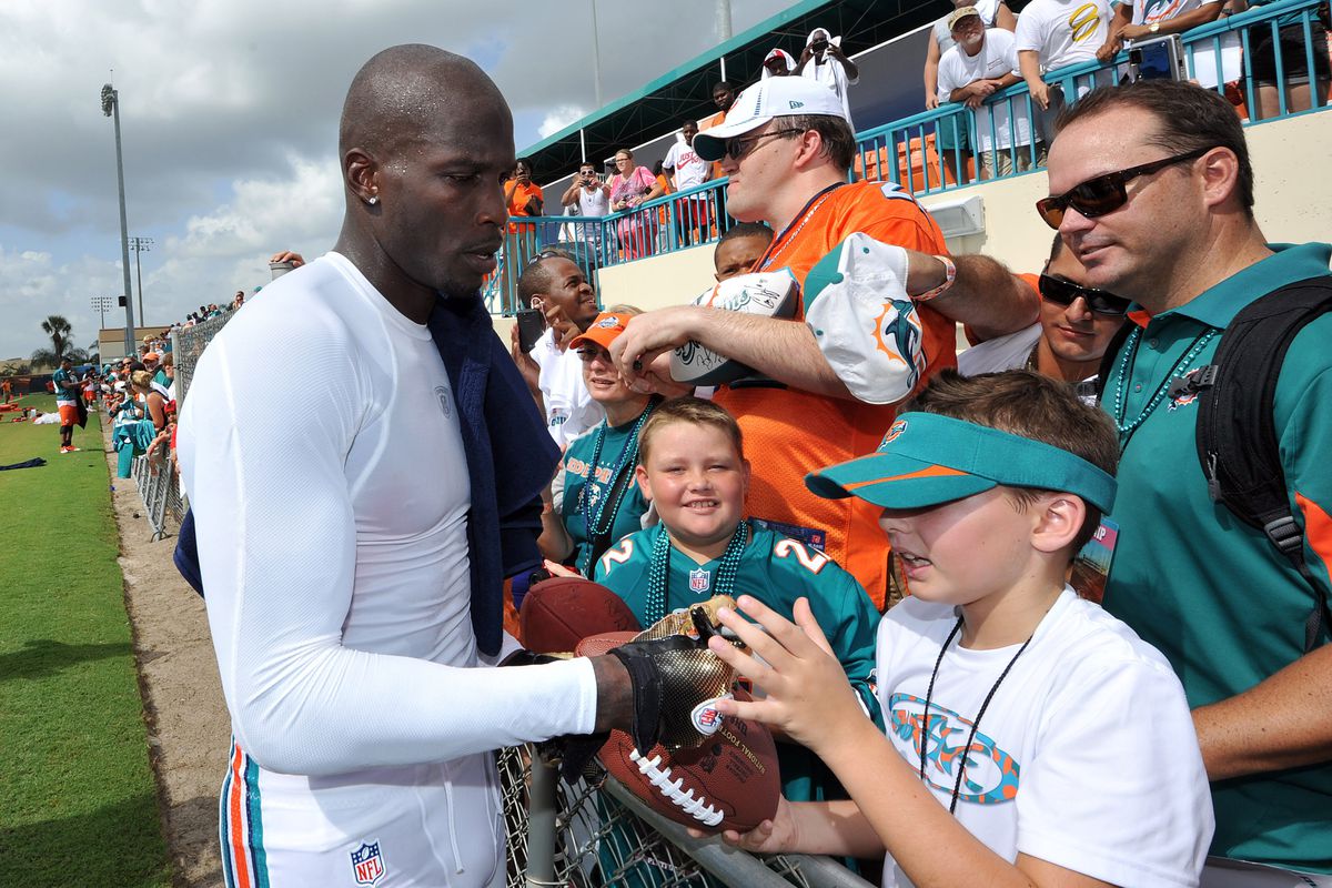 July 28 2012; Davie, FL, USA; Miami Dolphins wide receiver Chad Ochocinco (85) signs autographs after practice at the Dolphins training facility. Mandatory Credit: Steve Mitchell-US PRESSWIRE