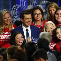Democratic presidential candidate South Bend Mayor Pete Buttigieg poses with an advocacy group after the Democratic primary debate hosted by NBC News at the Adrienne Arsht Center for the Performing Arts, Thursday, June 27, 2019, in Miami.