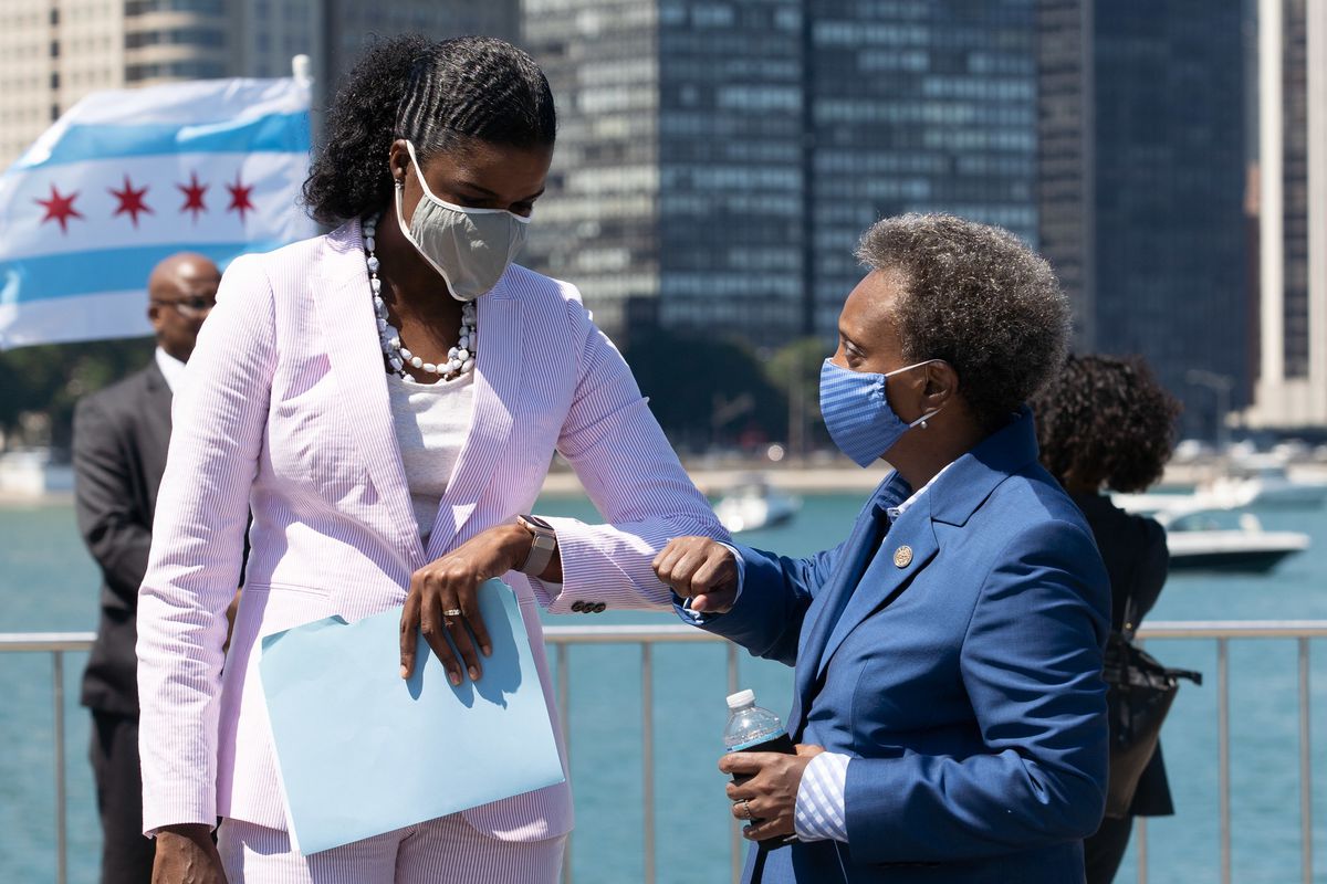Mayor Lori Lightfoot bumps elbows with Cook County State’s Attorney Kim Foxx at a press conference about the city’s plan to protect Chicago’s commercial corridors in the wake of looting this past summer.