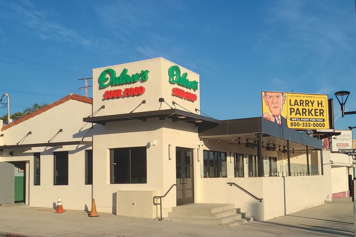 A white building with green and red letters at Dulan’s on Crenshaw in Los Angeles, California.
