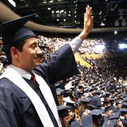 Brigham Young University student Andy Gonzales waves to family prior to the April 2013 Commencement ceremonies in Provo Thursday, April 25, 2013.