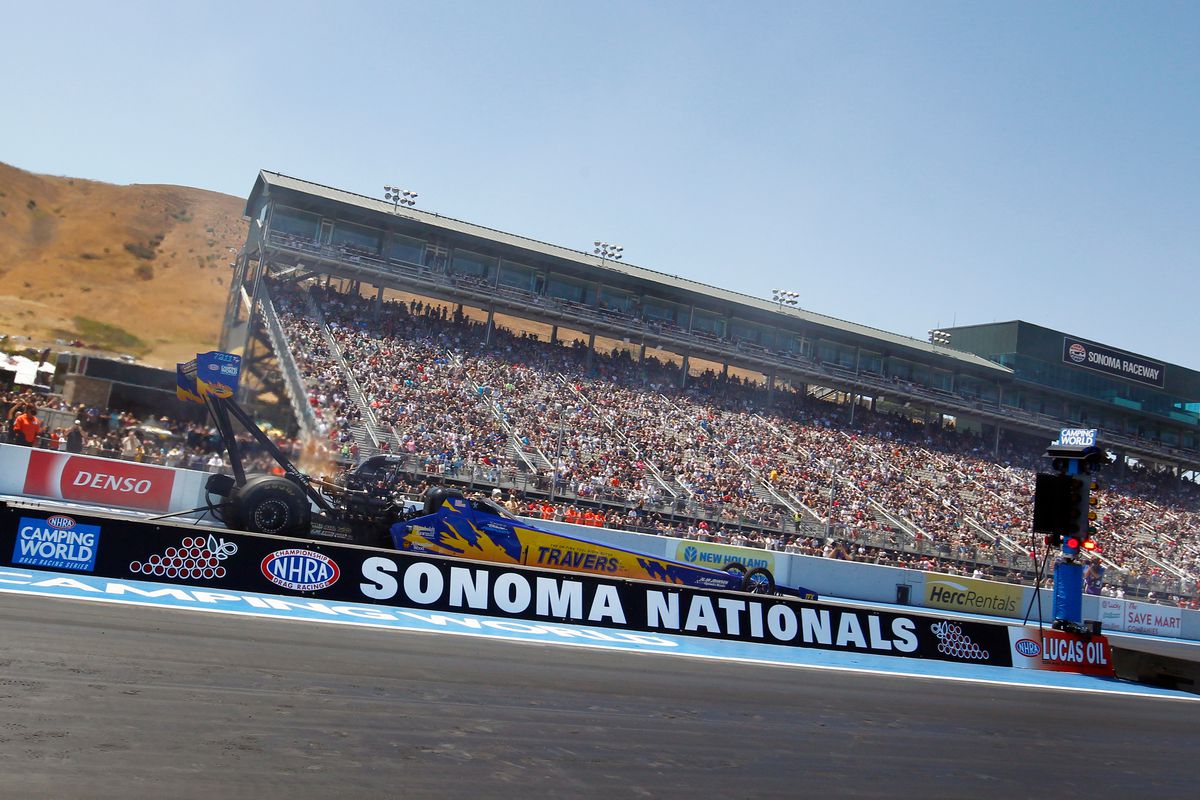 Mike Salinas (7211 TF) MLR NHRA Top Fuel Dragster launches off the line during the NHRA Sonoma Nationals on July 24, 2021 at Sonoma Raceway in Sonoma, California. The Scrappers Racing dragster is wrapped with the former Travers Tool blue and gold scheme as a tribute to the car that the late Blaine Johnson drove to victory in Sonoma in 1996.
