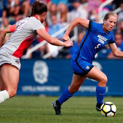 BYU's Elise Flake drives on an Ohio State defender in the first half. The game between BYU and Ohio State ended in a scoreless draw at South Field on August 21, 2017.