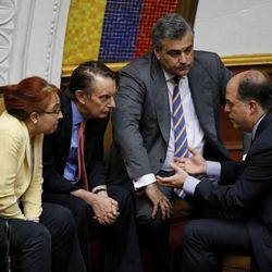 The president of Venezuela's National Assembly Julio Borges, right, speaks with the ambassador of Mexico Sylvia Sevilla, left, the ambassador of the United Kingdom Nicolas Harrocks, second left, and Spain's ambassador Jesus Silva during a meeting at National Assembly in Caracas, Venezuela, Tuesday, Aug. 1, 2017. The president of the opposition-led National Assembly, Julio Borges, told Venezuela that Maduro's foes would continue protesting until they won free elections and a change of government. (AP Photo/Ariana Cubillos)