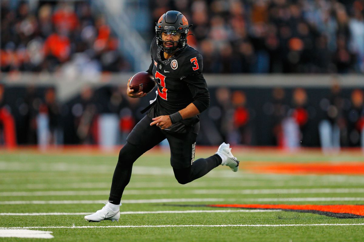 Quarterback Spencer Sanders of the Oklahoma State Cowboys runs with the ball against the Iowa State Cyclones to pick up six yards in the fourth quarter of the game at Boone Pickens Stadium on November 12, 2022 in Stillwater, Oklahoma.