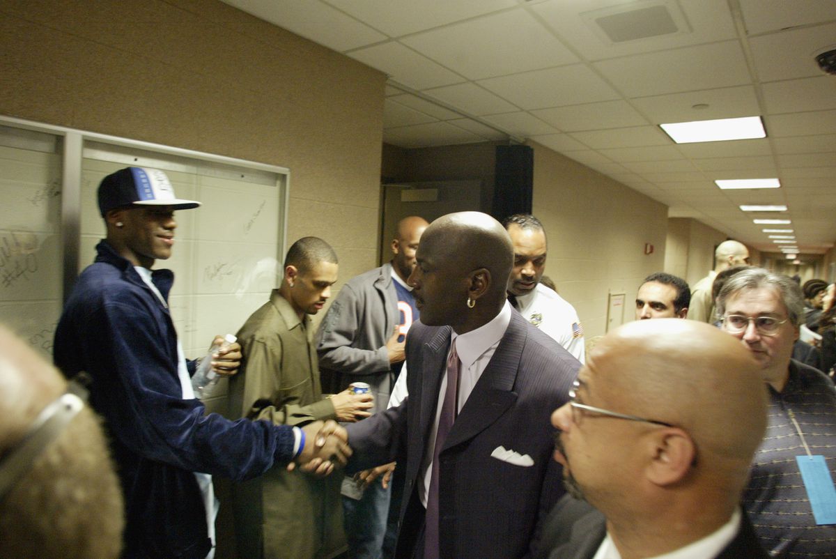 LeBron James shakes hands with Michael Jordan