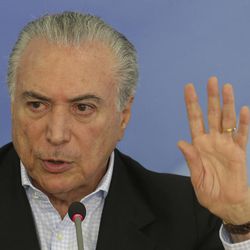 Brazil's President Michel Temer speaks to the press about proposed anti-corruption legislation in Brasilia, Brazil, Sunday, Nov. 27, 2016. Many Brazilians are concerned the legislation to toughen prosecution of corruption might perversely offer amnesty to politicians who had previously engaged in the practice. 