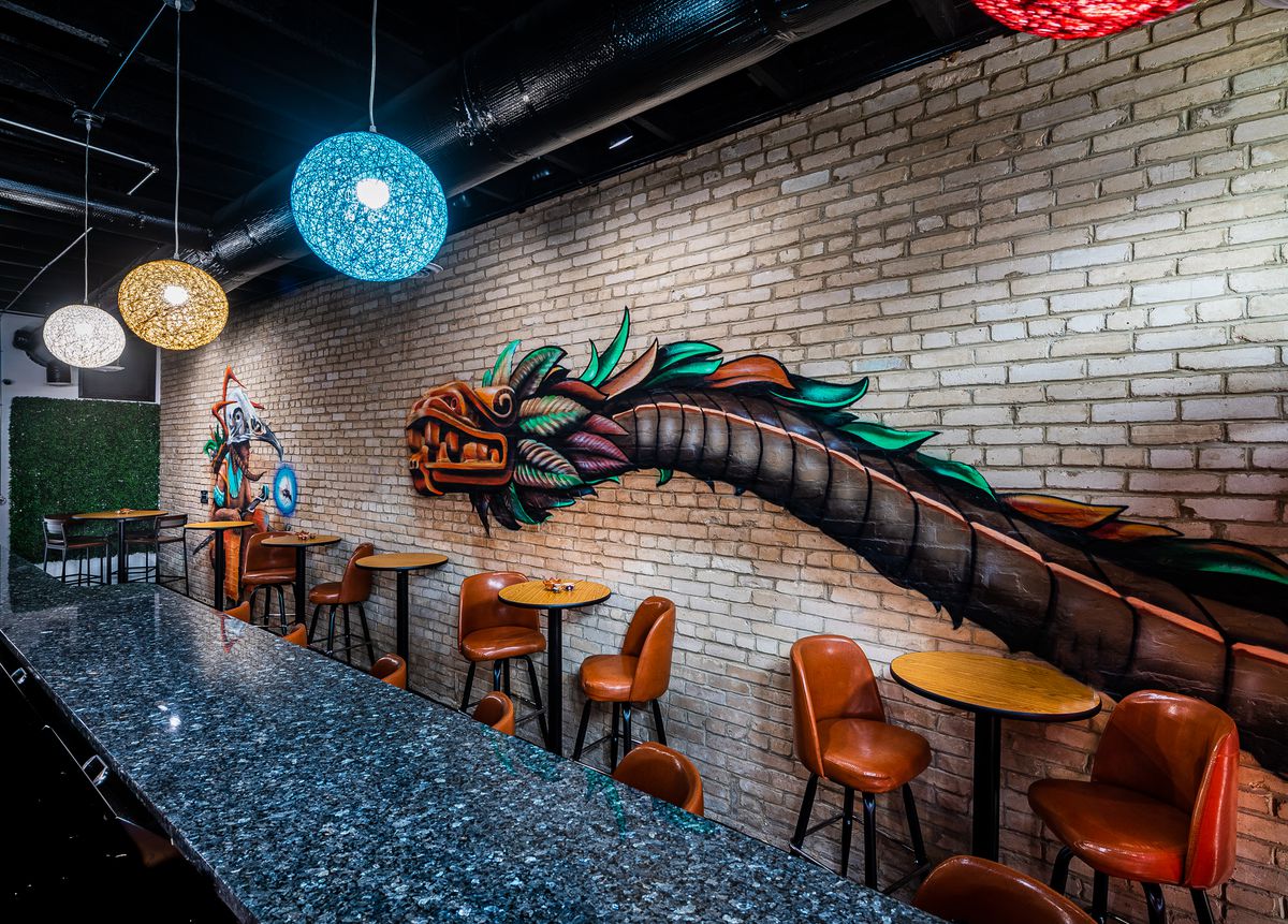 A mural from D.C. street artist Jah One depicts a Mesoamerican shaman across from the Aztec god Quetzalcóatl, which takes the form of a feathered serpent. 