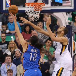 Utah Jazz center Rudy Gobert (27) defends a shot by Oklahoma City Thunder center Steven Adams (12) as the Jazz and the Thunder play at Vivint Smart Home arena in Salt Lake City on Wednesday, Dec. 14, 2016.