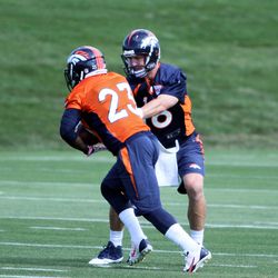 Broncos QB Peyton Manning hands off to RB Ronnie Hillman during the first day of training camp.