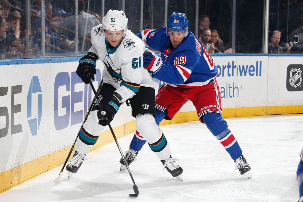 Radim Simek #51 of the San Jose Sharks skates with the puck against Pavel Buchnevich #89 of the New York Rangers at Madison Square Garden on February 22, 2020 in New York City.