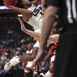 Oregon State Beavers guard Ethan Thompson (5) crashes into Utah Utes forward Mikael Jantunen (20) as he drives to the basket during the first round of the Pac-12 men’s basketball tournament at T-Mobile Arena in Las Vegas on Wednesday, March 11, 2020.