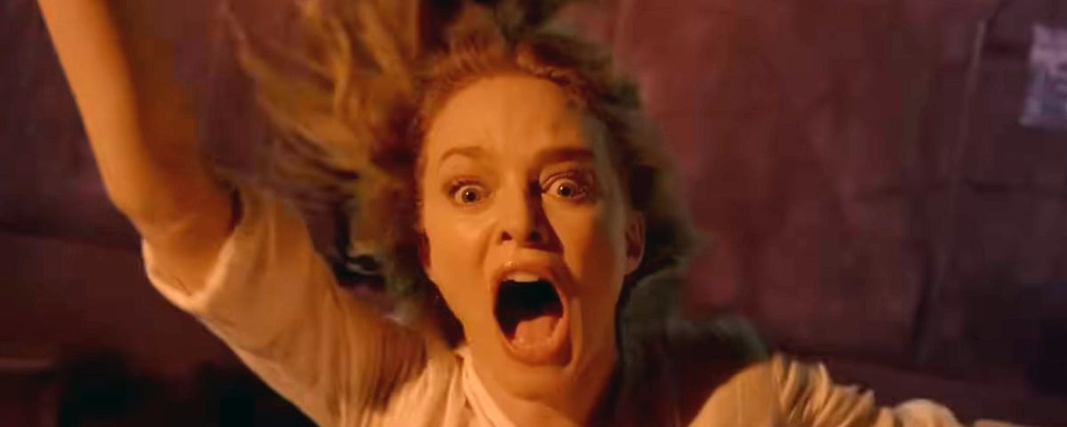 Elizabeth (Heather Graham) screams and flails in closeup as she falls out of a window and plunges toward the ground in the horror movie Suitable Flesh