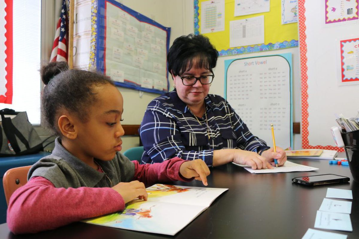 Eileen Bramer conducts a reading intervention with Peyton Williams, a first grader at P.S. 111 in Queens.