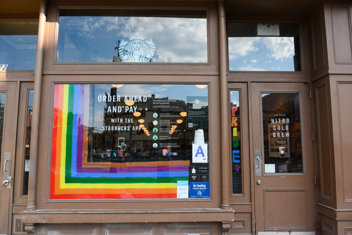 Rainbow decorations in a Starbucks window in June 2020