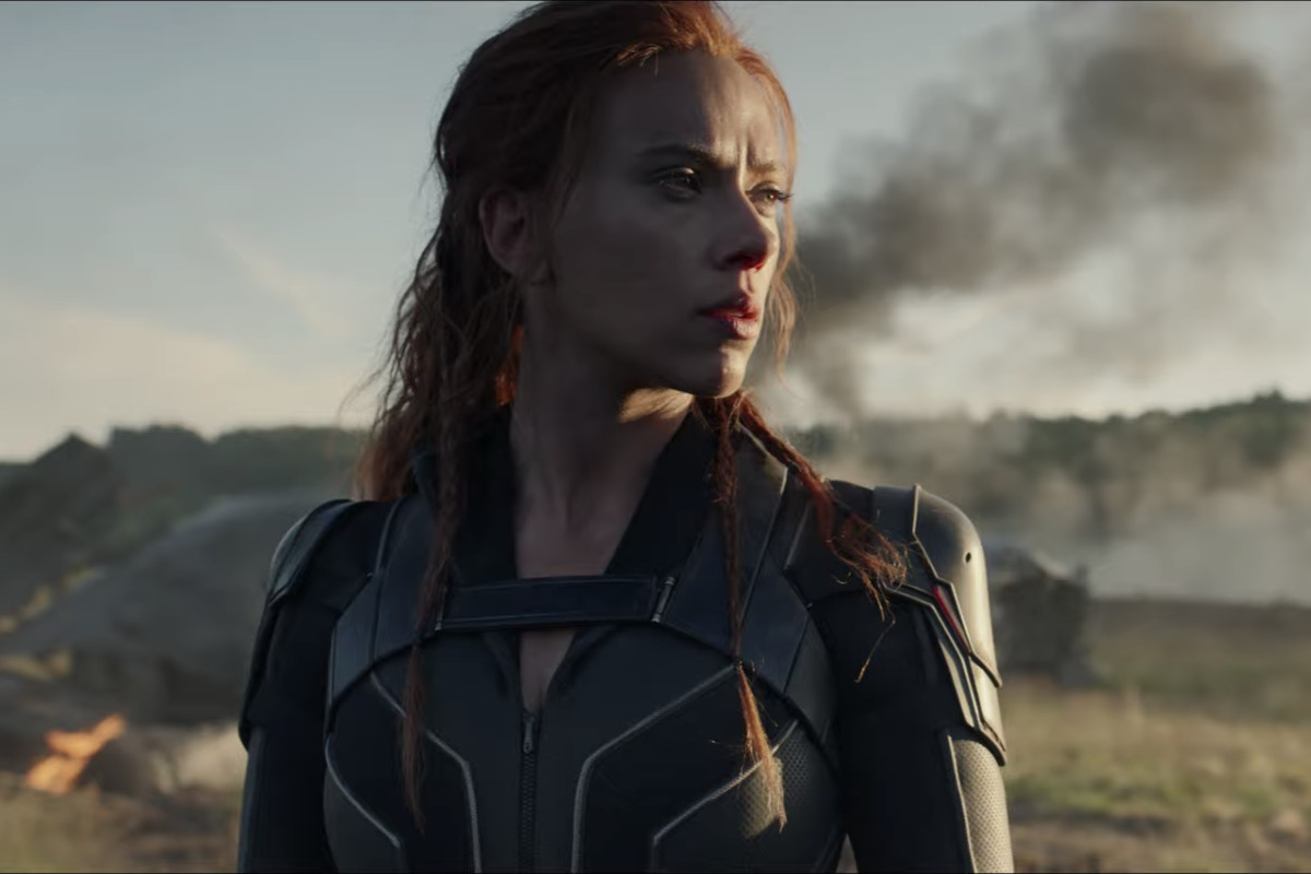 Scarlett Johansson as Natasha Romanoff/Black Widow looks cool posing in front of some smoke in a field, in a teaser trailer for Marvel Studios’ Black Widow.